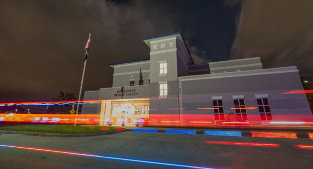 The Public Safety Department building at night with abstract lights in front